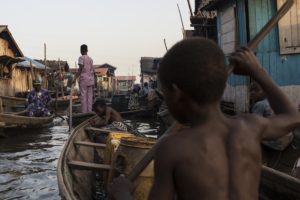 On 20 October 2016 in Lagos, Nigeria, a child navigates the polluted waters of Makoko, a fishing community mostly made up of structures on stilts above Lagos Lagoon. Vehicle emissions, diesel generators, burning of biomass and garbage and other environmental waste greatly affect the communities water and air quality. Residents of Makoko rely on fishing to make a living and complain that the fish stock has dwindled in recent years as a result. They also have trouble breathing and many cough out soot on a daily basis. Almost one in seven of the worldís children, 300 million, live in areas with toxic levels of outdoor air pollution - six times higher than international guidelines according to a report from UNICEF, Clear the Air for Children, released ahead of COP 22. UNICEFís findings, the first of its kind and based on satellite imagery, also show that around 2 billion children in total live in areas where outdoor air pollution exceeds limits set by the World Health Organization as being safe for human health. This air pollution is caused by factors such as vehicle and factory emissions, heavy use of fossil fuels, dust and burning of waste. Indoor pollution is commonly caused by use of fuels like coal and wood for cooking and heating. Taken together, outdoor and indoor air pollution are one of the leading dangers facing children -- they are a contributing factor in the deaths of almost 600,000 children under five every year. This figure represents nearly 1 in 10 under-five deaths. Air pollution is also linked with poor health and diseases among millions more children that can severely affect their overall wellbeing and development. It causes difficulty breathing; studies show it is linked with, and can exacerbate asthma, bronchitis, and the inflammation of airways, as well as other underlying health issues. Children who breathe polluted air are at higher risk of potentially severe health problems-- in particular, acute respiratory infections such as pneumoni